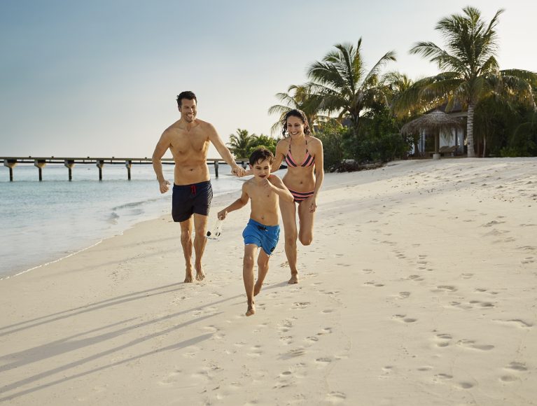 Familie am Strand: Flitterwochen mit Kindern auf den Malediven